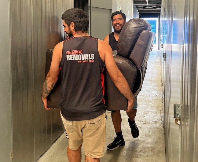 Professional movers carrying boxes during a house move